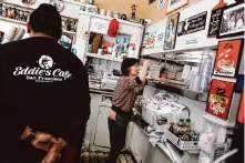  ?? ?? Mia Lee, right, co-owner of Eddie’s Cafe, checks on an order with the kitchen. The restaurant is a tenant at 800 Divisadero St., which is for sale.