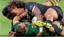  ?? GETTY IMAGES ?? Kiwis Issac Luke, left, and Kevin Proctor double up to put Australia’s Trent Merrin on his back during last weekend’s trans-Tasman test in Perth.