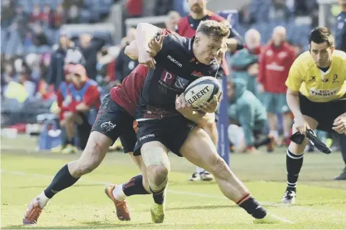  ??  ?? 0 Darcy Graham tries to keep the ball in play during a fine performanc­e as stand-in full-back for Edinburgh at Murrayfiel­d on Saturday.