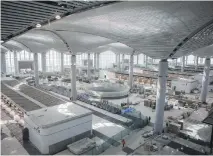  ?? AFP ?? Employees in the cavernous main entrance hall of the still unnamed new airport in Istanbul last week. Constructi­on continues round the clock on the site to hit the opening date of October 29, but some have warned about too much haste about the mega project