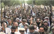  ?? Rahmat Gul / Associated Press ?? Militiamen, deployed to help fight the Taliban, join security forces during a recent gathering in Kabul.