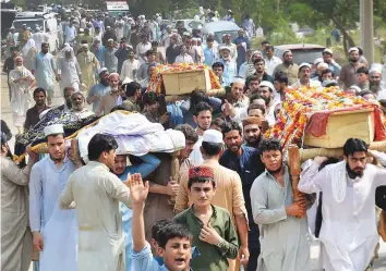  ?? AP ?? People carry the coffins of victims of the suicide bombing. The funeral for Haroon Ahmad Bilour, a candidate killed in the attack, was to be held yesterday.