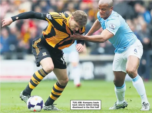  ??  ?? TUG JOB: Kompany hauls back Jelavic before being dismissed in the first half