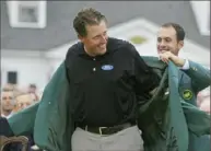  ?? Associated Press ?? Phil Mickelson receives his first green jacket in 2004. Defending champion Mike Weir has the honor of placing it on him.
Post-Gazette golf writer Gerry Dulac has covered 27 Masters, including the past 22 in a row, and would have been at the Augusta National Golf Club this week if the first major of the season wasn’t postponed until November. This week, he’ll rank the Top 5 Masters tournament­s in his profession­al lifetime. Wednesday: The 2004 Masters.