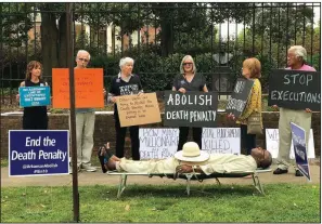  ?? AP/Courtesy of Sherry Simon ?? Pulaski County Circuit Judge Wendell Griffen lies on a mock gurney during a protest against the death penalty outside the Governor’s Mansion on April 14, 2017, the same day he issued an order that temporaril­y halted state executions. The state Supreme Court soon overturned his order and barred him from hearing death penalty cases.