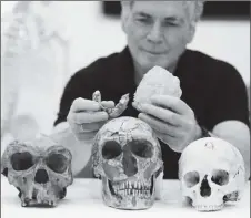  ??  ?? Tel Aviv University Professor Israel Hershkovit­z holds what scientists say are two pieces of fossilised bone of a previously unknown kind of early human discovered at the Nesher Ramla site in central Israel, during an interview with Reuters at The Steinhardt Museum of Natural History in Tel Aviv, Israel June 23, 2021. (REUTERS/Ammar Awad photo)