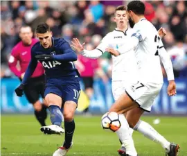  ??  ?? Tottenham Hotspur’s Erik Lamela, left, scores his side’s second goal of the game against Swansea City Photo: AP