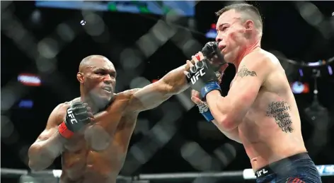  ?? STEVE MARCUS/AFP PHOTO ?? SHOW UTAMA: Kamaru Usman melepaskan pukulan yang mengarah ke wajah Colby Covington saat duel kelas welter UFC 245 di T-Mobile Arena, Las Vegas (14/12).