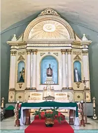  ??  ?? The oldest main altar in the province is embellishe­d with gold leaf and painted friezes.