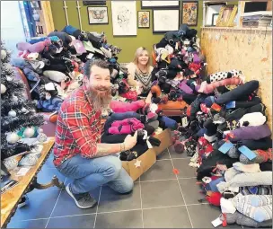  ??  ?? Matt Wall and Gemma Iliff with all the socks donated by people from Leek and the Staffordsh­ire Moorlands.