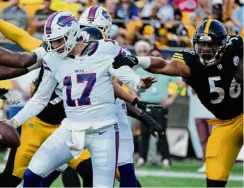  ?? ?? Gene Puskar/Associated Press Bills quarterbac­k Josh Allen tries to avoid a tackle by Steelers linebacker Alex Highsmith in the first half of Saturday’s preseason game in Pittsburgh. Allen completed 7 of 10 passes for 64 yards. For full details, go to timesunion.com/sports.