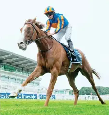  ?? — AFP photo ?? Jockey Ryan Moore rides Love to victory in the Oaks Stakes at the Epsom Derby Festival, south of London.