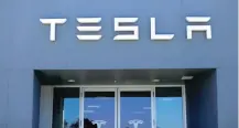  ?? — Reuters ?? A Tesla sales and service centre is shown in Costa Mesa, California.