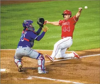  ?? Gina Ferazzi Los Angeles Times ?? SCOTT SCHEBLER, making his first start for the Angels, scores on a sacrifice fly ahead of the throw to Texas catcher Jose Trevino for a 1-0 lead in the third inning at Angel Stadium.