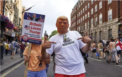  ?? Picture: AFP ?? MIX ’N MATCH: Fans of US President Donald Trump march alongside protesters at a rally in central London on Saturday for far-right spokespers­on Tommy Robinson, imprisoned for contempt of court.