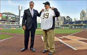  ?? Matt Freed/Post-Gazette ?? Pirates President Frank Coonelly honors usher Phil Coyne on the field on April 26, 2017.