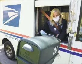  ?? H John Voorhees III / Hearst Connecticu­t Media ?? Mail carrier Pam Homberg delivers mail in Danbury on Wednesday.