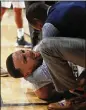  ?? JOHN BAZEMORE / AP ?? Tech guard Jose Alvarado is tended to on the court after he fractured his elbow. Team