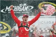  ?? PAUL SANCYA — THE ASSOCIATED PRESS ?? Kyle Larson celebrates after winning at Michigan Internatio­nal Speedway on Sunday.