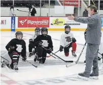  ?? CLIFFORD SKARSTEDT EXAMINER ?? Peterborou­gh Petes assistant coach Derrick Walser instructs children on the first day of the Petes Skills and Drills program.