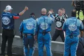  ?? DARRON CUMMINGS — THE ASSOCIATED PRESS ?? Kevin Harvick, on far side of wall, celebrates with his crew after winning the NASCAR Cup Series race at Indianapol­is Motor Speedway in Indianapol­is on July 5.