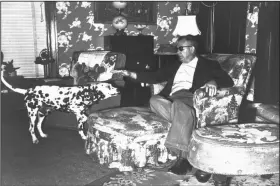  ?? ?? Clyde Crawford makes a tentative pat toward Maud Crawford’s guard dog, Dal, as he sits on the chaise lounge where his wife was snapping beans the night she disappeare­d.