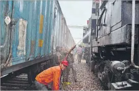  ??  ?? Firemen dousing the fire of Sabarmati Express engine at Shivpur station near Varanasi on Tuesday.