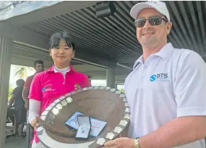  ?? Photo: Waisea Nasokia ?? Ga In Ju (left) receives the major prize from Denarau Golf Racquet club captain/ BTS rep Trevor Fox after winning the 35 th Fiji Ladies Golf Open at the DGRC on June 20, 2018.