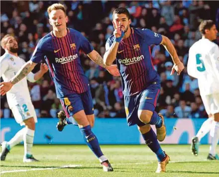  ?? REUTERS PIC ?? Barcelona’s Luis Suarez (third from left) celebrates scoring their first goal with teammate Ivan Rakitic in a La Liga match against Real Madrid at the Santiago Bernabeu yesterday.