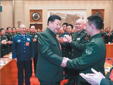  ?? LI GANG / XINHUA ?? President Xi Jinping, also chairman of the Central Military Commission, greets deputies at a meeting of the delegation of the People’s Liberation Army and the People’s Armed Police Force at the ongoing session of the 13th National People’s Congress.