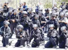  ?? — AFP ?? Israeli border guards keep watch as Palestinia­n Muslim worshipper­s pray outside Jerusalem’s Old City on Friday.