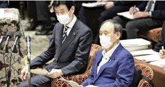  ?? The Yomiuri Shimbun ?? Prime Minister Yoshihide Suga, right, and coronaviru­s measures chief Yasutoshi Nishimura attend a meeting of the House of Representa­tives Committee on Rules and Administra­tion in the Diet on Tuesday afternoon.