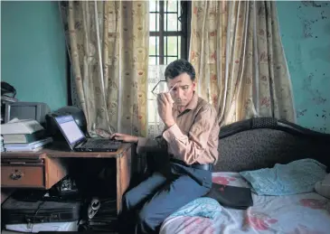  ?? AP ?? Suman Adhikari, son of Muktinath Adhikari, is seen at his home in Kathmandu on Aug 9. Mr Adhikari has very little hope of getting justice for his father who was dragged out of a classroom, tied to a tree and riddled with bullets by alleged Maoists.