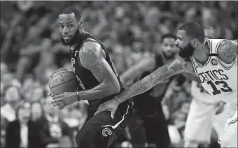  ?? CHARLES KRUPA/AP PHOTO ?? Cavaliers forward LeBron James, left, is pressured by Celtics forward Marcus Morris (13) during Game 5 of the NBA Eastern Conference finals on Wednesday night at Boston.