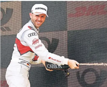  ?? FOTO: JÜRGEN TAP/DPA ?? René Rast feiert seinen Sieg im zweiten Rennen der DTM in Brands Hatch mit Champagner. Der Deutsche fährt für das Audi-SportTeam-Rosberg.