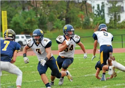  ?? SAM STEWART - DIGITAL FIRST MEDIA ?? Upper Perkiomen’s Tyler Whary gets a block from Ryan Kendra (5) and Austin Tutolo (3) before finding space to run. Whary finished with 114 rushing yards and two touchdowns as Upper Perkiomen downed previously undefeated PJP, 41-14.