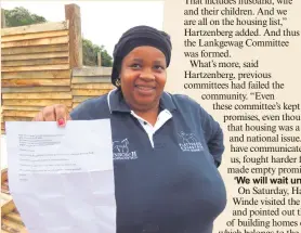  ?? Photos: Stefan Goosen ?? Elsperth Hartzenber­g of the Lankgewag Committee in Smutsville, Sedgefield holds up proof from Knysna’s manager of integrated human settlement­s Mawethu Penxa that she can set up her informal home on the spot behind her. Residents marking plots out...