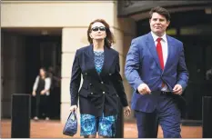  ?? Al Drago / Bloomberg ?? Kathleen Manafort, wife of former Donald Trump campaign manager Paul Manafort, left, exits District Court in Alexandria, Va., on Friday. Trump declined to comment Friday on whether he'll pardon Manafort, whose fate is in the hands of jurors deliberati­ng an 18-count indictment for a second day.
