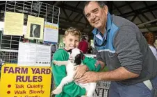  ?? Photo: Kevin Farmer ?? IT’S A ZOO: Ten-year-old volunteer Darcy Lewis and long-time volunteer David Budden help out at Viv’s Farm Animals animal nursery at the Heritage Bank Toowoomba Royal Show. TOM GILLESPIE