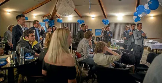  ?? PHOTO: GRANT MATTHEW/STUFF ?? Jonathan Young’s supporters get to their feet at the Plymouth Hotel as they watch the results go National’s way.