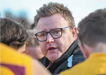  ?? ?? Drouin senior coach Brent Clinnick addresses his players at three quarter time as they hold a 30-point advantage.