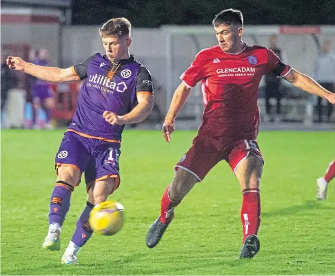  ??  ?? Cammy Smith pounces ahead of Brechin’s Gregor Jordan to score his first and United’s fifth goal of the night.