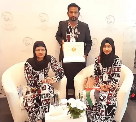  ?? ?? Team Kamil Muslim College in Dubai, Nawaila Nafisha Ali (left), Aqeelah Laylaa Ali (right) with their teacher, Rinal Prasad after winning the Zayed Sustainabi­lity Prize, under the Global High Schools category.