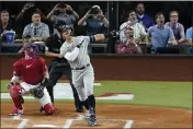  ?? TONY GUTIERREZ — THE ASSOCIATED PRESS ?? The New York Yankees’ Aaron Judge follows through on a solo home run, his 62nd of the season, as Texas Rangers catcher Sam Huff, left, and umpire Randy Rosenberg, rear, look on in the first inning of the second game of a doublehead­er in Arlington, Texas, on Tuesday.