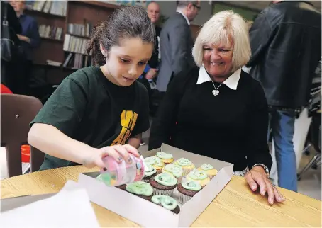  ?? TYLER BROWNBRIDG­E ?? Grade 4 student Kailyn Brennan, left, decorates cupcakes with her mentor Sandy Ladouceur on Wednesday during the Big Brothers Big Sisters of Windsor Essex’s Between Generation­s Intergener­ational Mentoring Program at St. Bernard Catholic elementary...