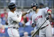  ?? NICK WASS - THE ASSOCIATED PRESS ?? Boston Red Sox’ Rafael Devers, left, celebrates his home run with J.D. Martinez, right, during the fourth inning of a baseball game against the Washington Nationals, Saturday, Oct. 2, 2021, in Washington.