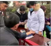  ?? PHOTOS BY YANG JUN / CHINA DAILY ?? Activities such as free health checks and performanc­es are held to celebrate Spring Festival in Tangyue village, Guizhou province.