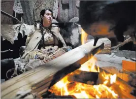  ?? Steven Senne ?? The Associated Press Mashpee Wampanoag Tribe member Kerri Helme, of Fairhaven, Mass., uses plant fiber Nov. 15 to weave a basket at Plimoth Plantation in Plymouth, Mass.