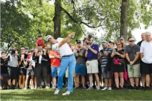  ?? Nam Y. Huh/Associated Press ?? ■ Justin Thomas hits his second shot on the first hole Sunday during the final round of the BMW Championsh­ip golf tournament at Medinah Country Club in Medinah, Ill.