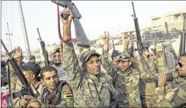  ?? MARKO DROBNJAKOV­IC / ASSOCIATED PRESS ?? Iraqi army soldiers raise their weapons Wednesday in celebratio­n near Qayyarah, Iraq. A senior Iraqi general urged Iraqis fighting for the Islamic State group in Mosul to surrender as an operation to retake the city entered its third day.